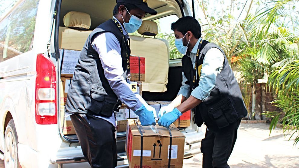 International Rescue Committee representatives unload a delivery at a refugee camp in Bangladesh.