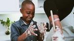 Boy cooking with sticky fingers. Family meal plans and activities were key F&R initiatives during lockdown.
