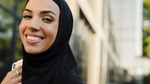 Woman wearing a hijab holding a phone