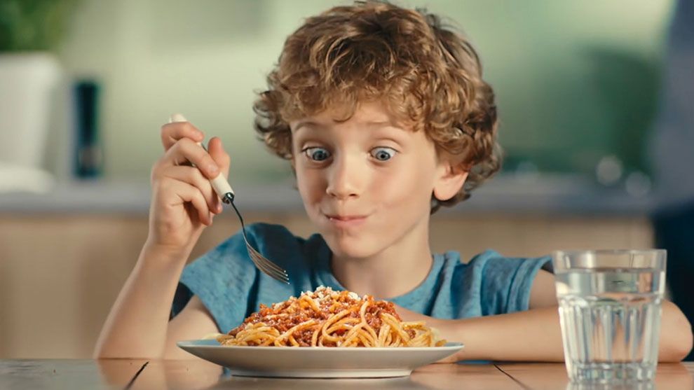 A boy tucks into a plate of food