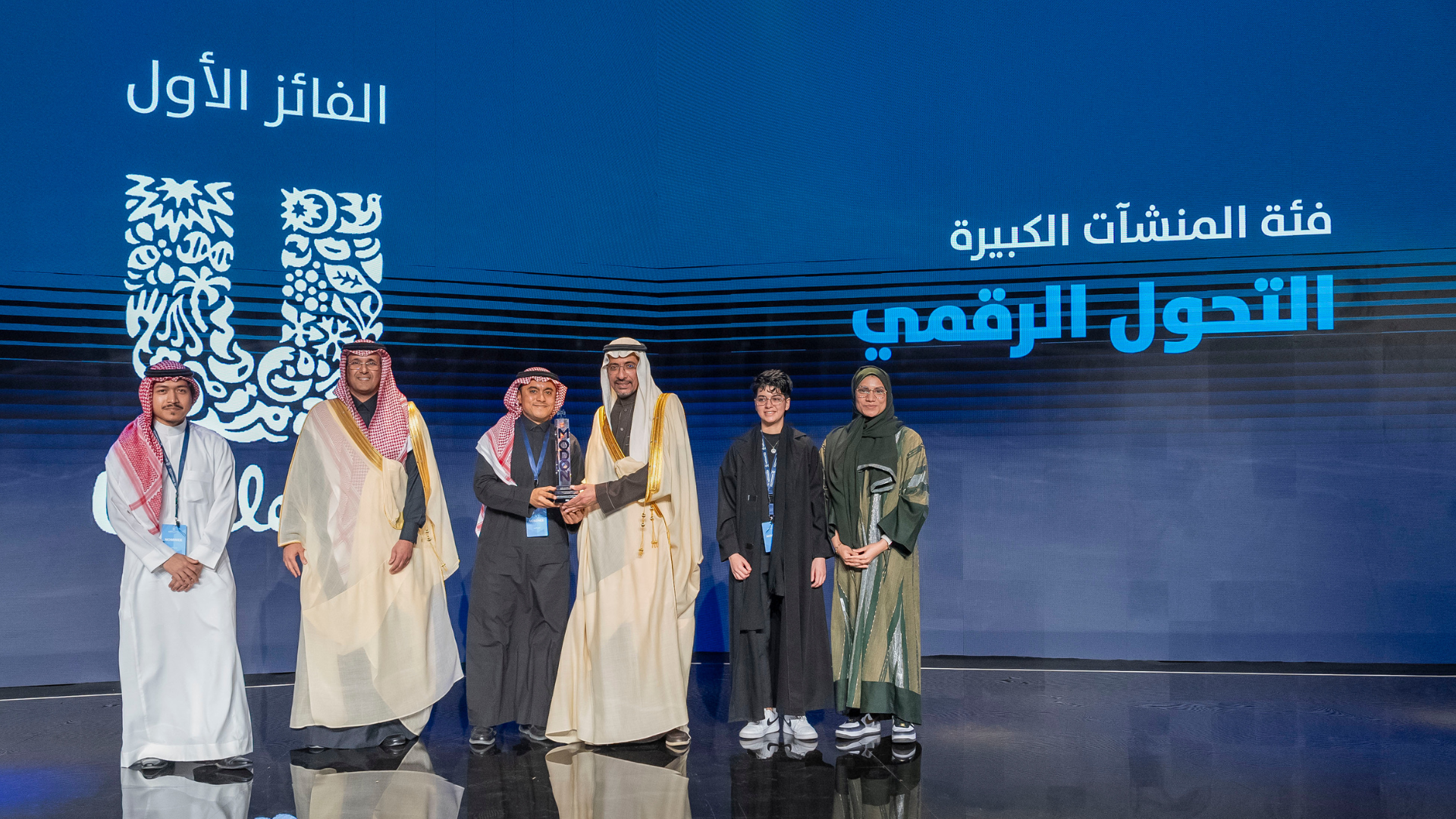 BUL team taking group picture on the stage