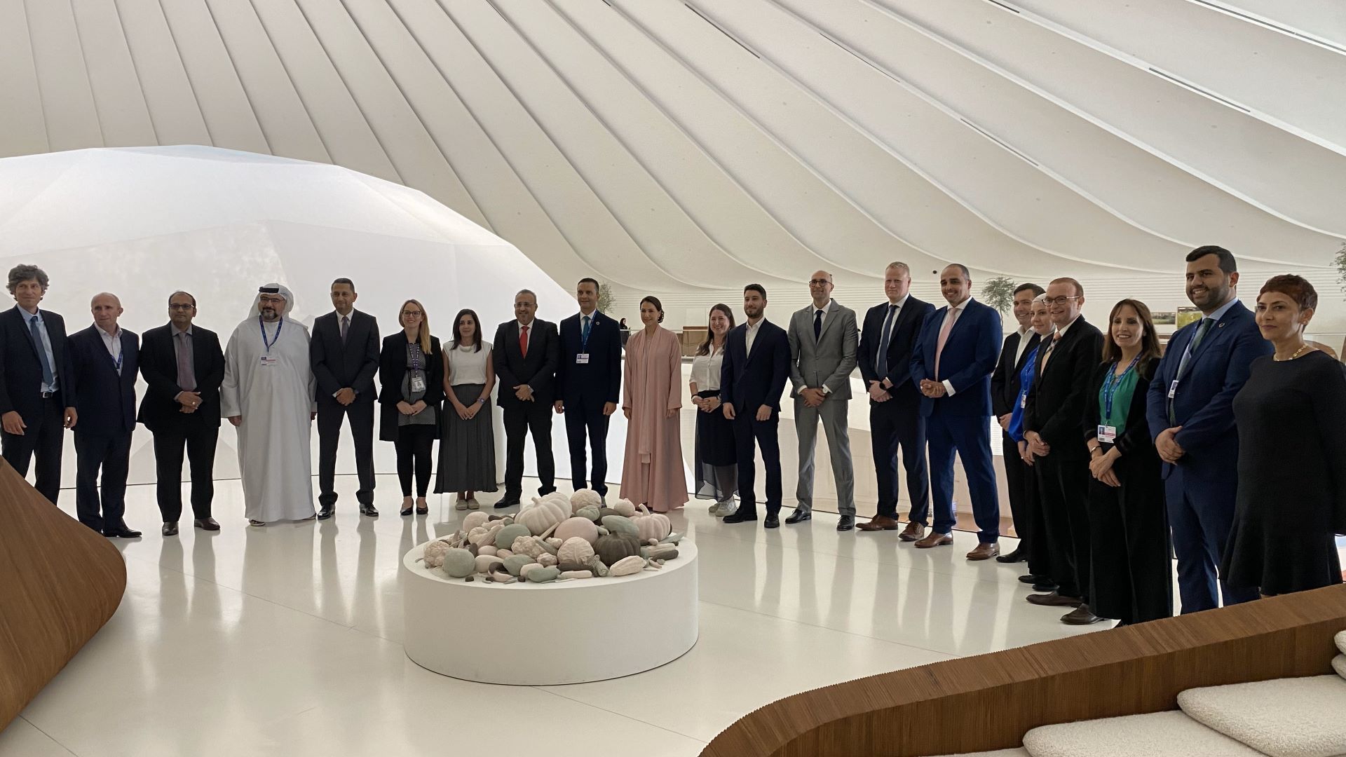 Group of leaders standing taking a picture in celebration of the singing of the pledge.