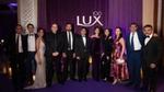 A group of employees at the 100th anniversary of the Lux brand