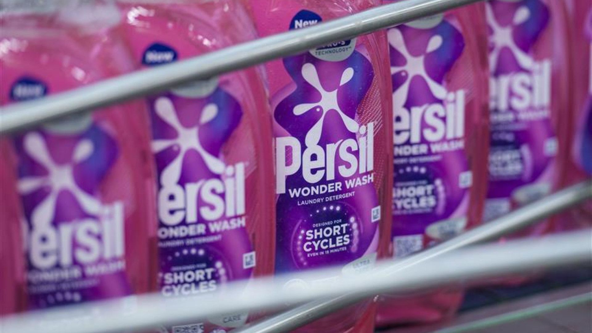 Multiple pink bottles of Wonder Wash lined up.